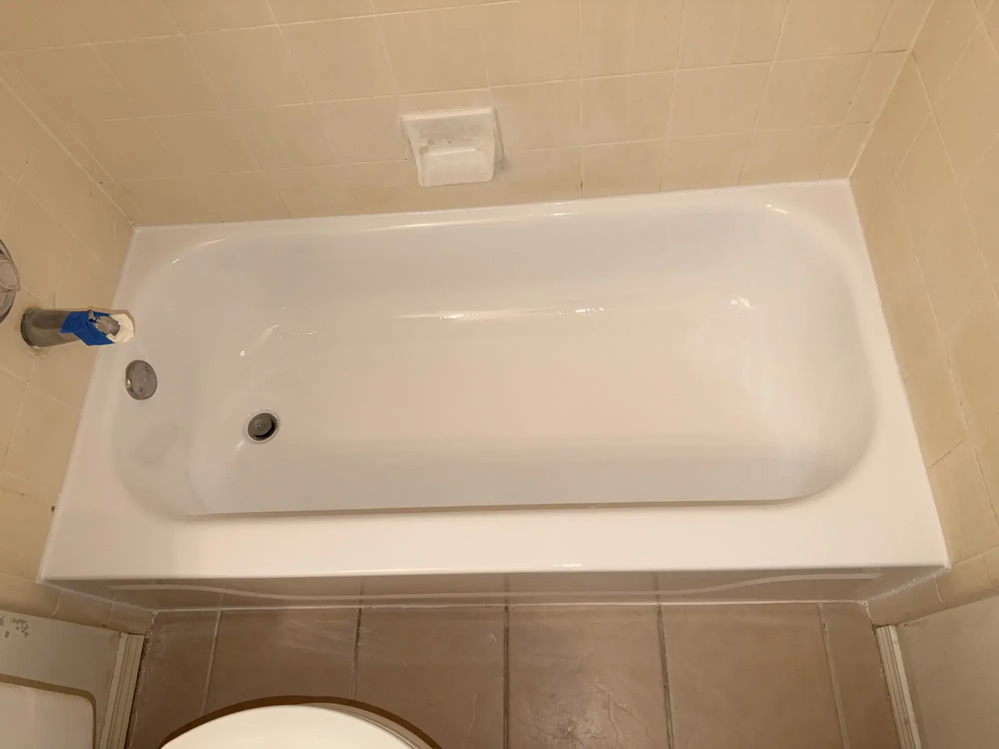 The same bathtub after refinishing, renewed white surface
