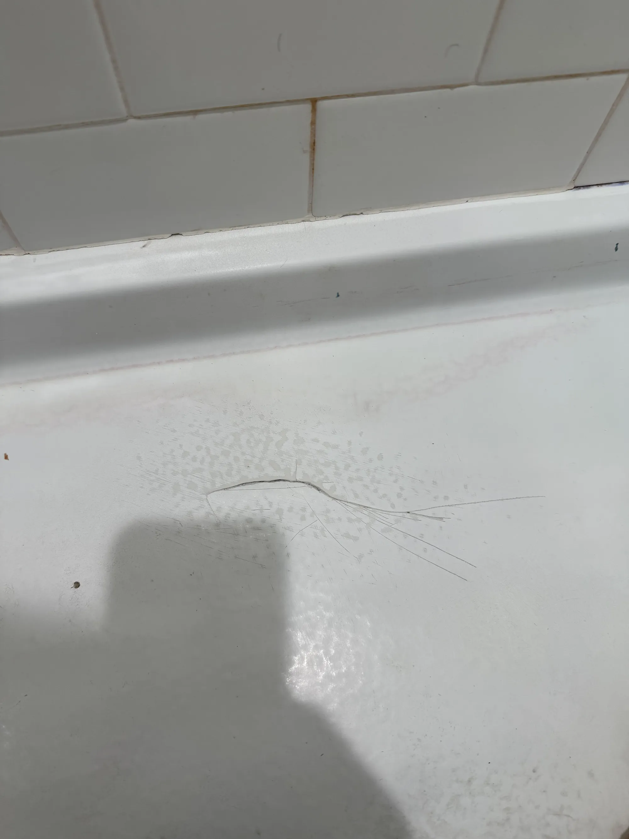 Cracked shower pan before repair