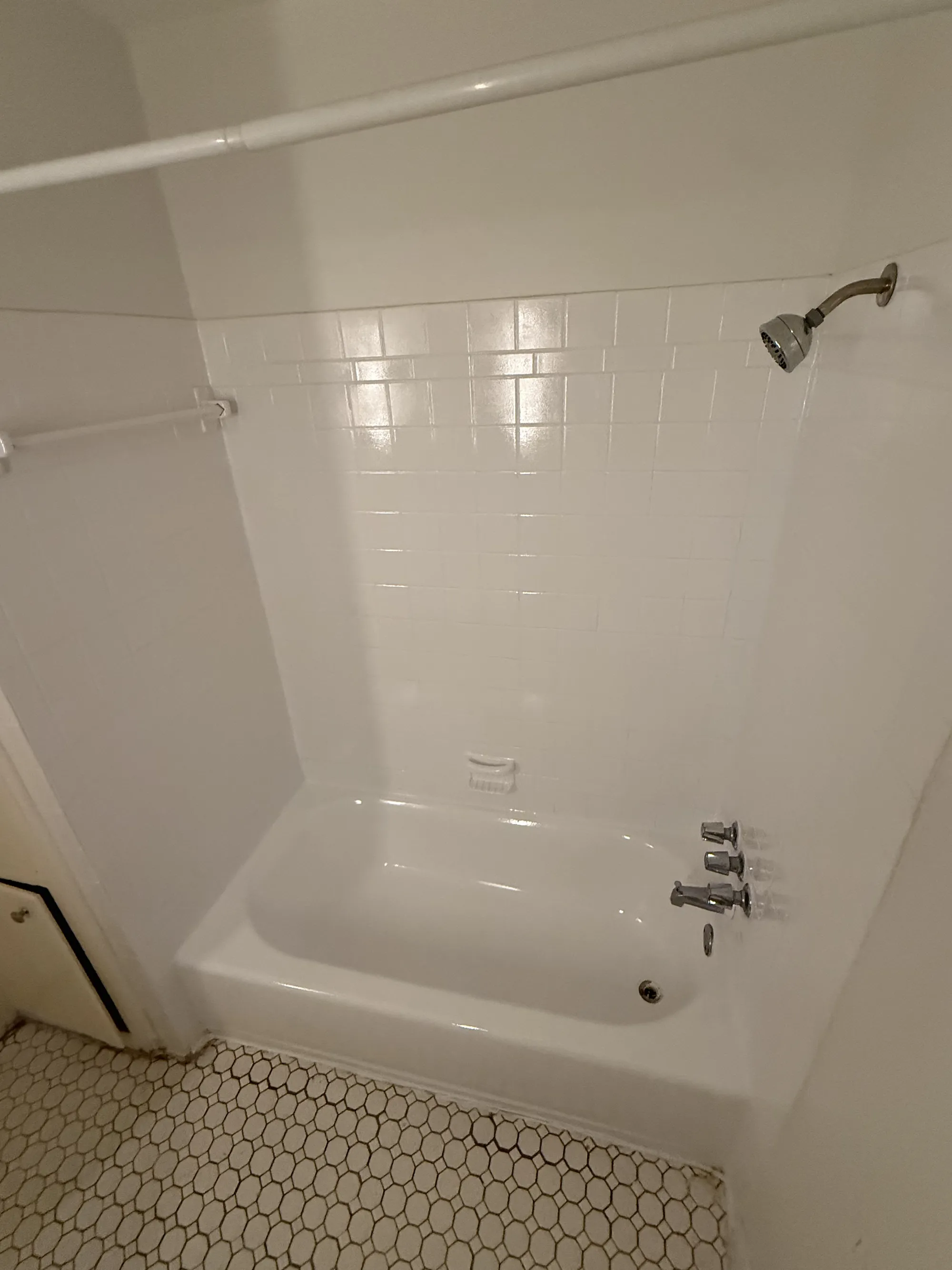 The same tub-and-shower combo refinished to bright white