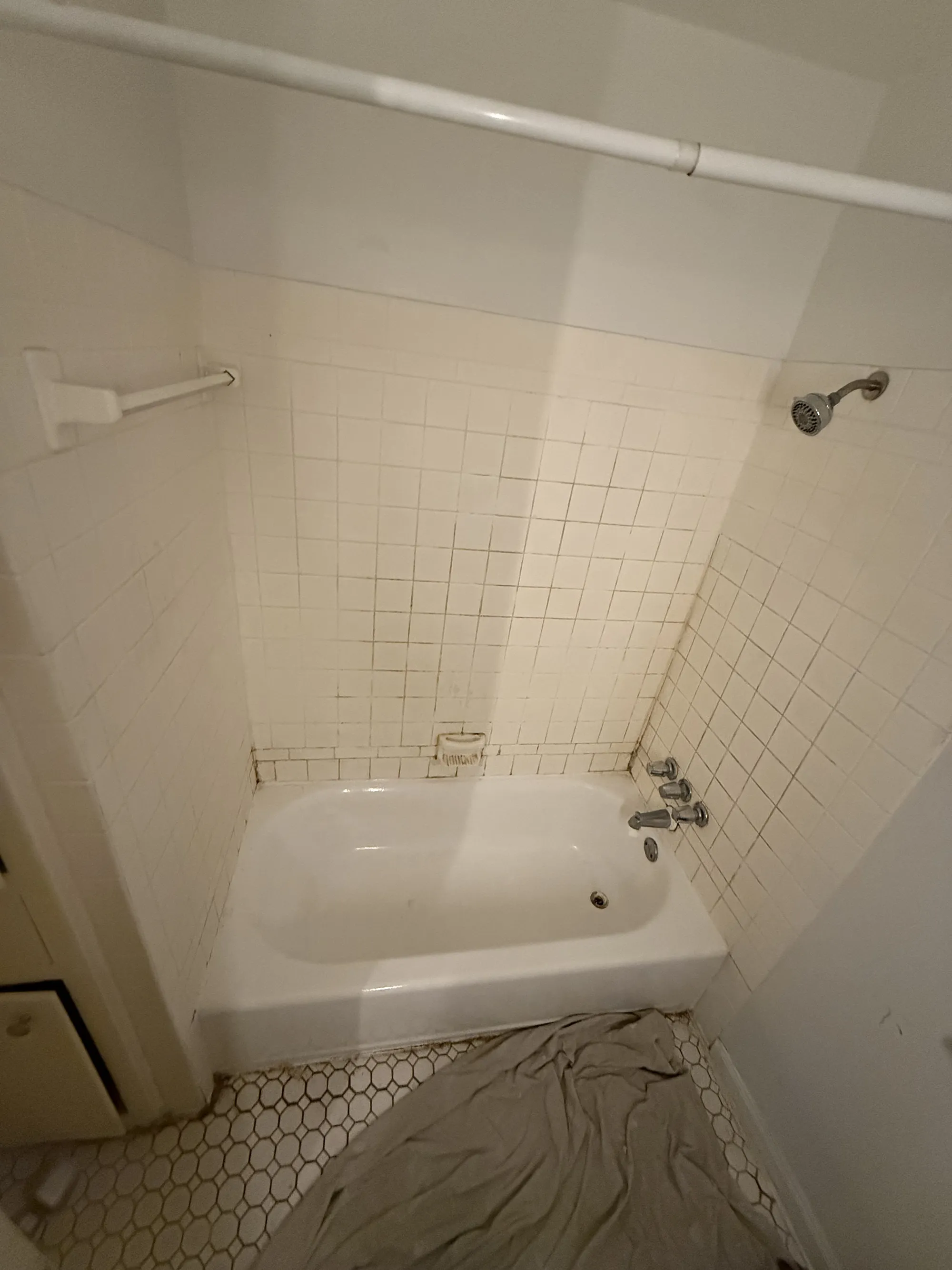 Tub-and-shower combo with mildewed tile before refinishing